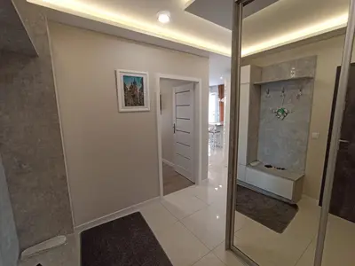 a hallway with a glass door in a house at APARTAMENTY BARSKA 69 in Kraków