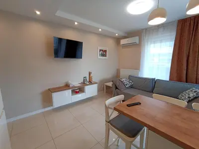 a living room with a couch and a table at APARTAMENTY BARSKA 69 in Kraków
