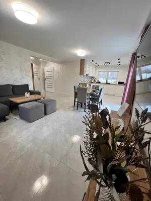 a living room with a couch and a table at ZATOR Apartamenty Max House, Energylandia in Zator