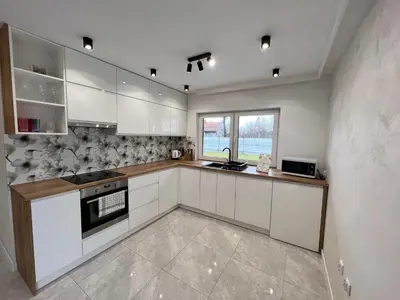 a kitchen with white cabinets and a stove top oven at ZATOR Apartamenty Max House, Energylandia in Zator