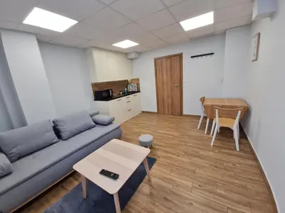 a living room with a couch and a table at Apartament Łąki18 in Wadowice