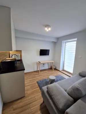 a living room with a couch and a table at Apartament Łąki18 in Wadowice