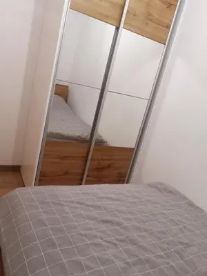a bedroom with a bed and a mirror at Apartament Źródełko in Bochnia