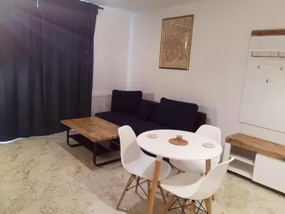 a living room with a table and a couch at Apartament Źródełko in Bochnia