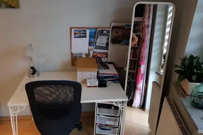 a desk with a chair next to a closet at Miło powitać Cię w Krakowie. in Kraków