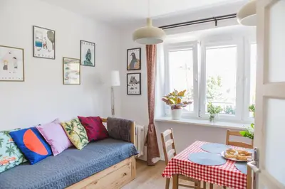 a living room with a couch and a table at Cosy Apartment 2 in Kraków
