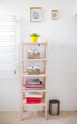 a book shelf with towels on it in a room at Cosy Apartment 2 in Kraków