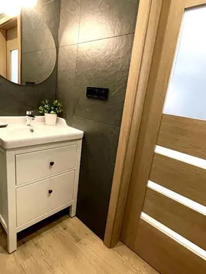 a bathroom with a sink and a mirror at RiversideSuite. Krakow in Kraków
