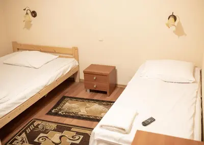a room with two beds and a night stand and a bedskirts at NOCLEGI General in Wieliczka