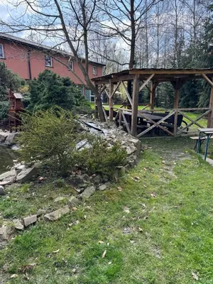 a wooden bridge in front of a red building at NOCLEGI General in Wieliczka