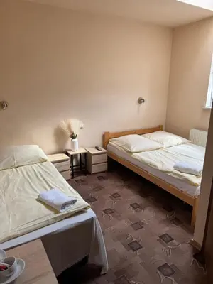 a bedroom with two beds and a window at NOCLEGI General in Wieliczka