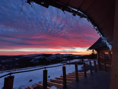 a winter sunset from the porch of a cabin at Wrzosowy Dwór - SPA in Skomielna Czarna