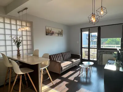 a living room with a couch and a table at Apartament Raffi in Kraków