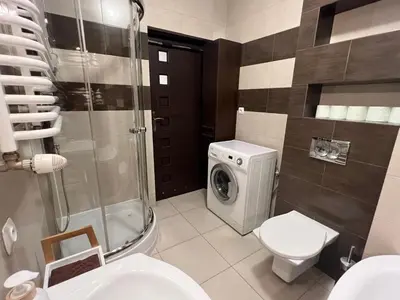 a bathroom with a shower and a sink and a toilet at Apartament Raffi in Kraków