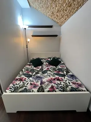 a bathroom with a washing machine and a toilet at Apartament Raffi in Kraków