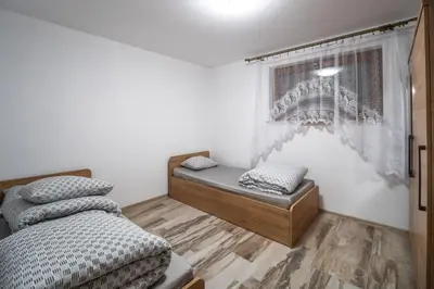 a bedroom with two beds and a window at Michalka 1 - Domki pod Leskowcem in Targoszów