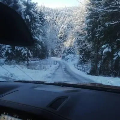 a view of a snow covered road from a car at Michalka 1 - Domki pod Leskowcem in Targoszów