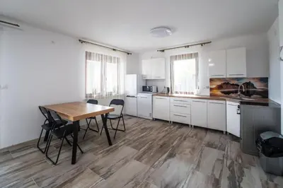 a kitchen with a table and chairs in a room at Michalka 1 - Domki pod Leskowcem in Targoszów