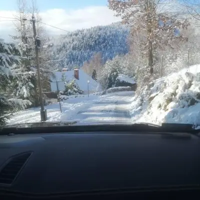 a view of a snow covered street from a car at Michalka 2 - Domki pod Leskowcem in Targoszów