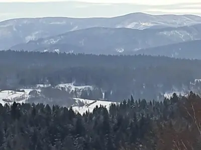 a view of a mountain range with trees and snow at Michalka 2 - Domki pod Leskowcem in Targoszów