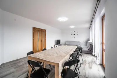 a room with a table and chairs and a couch at Michalka 2 - Domki pod Leskowcem in Targoszów