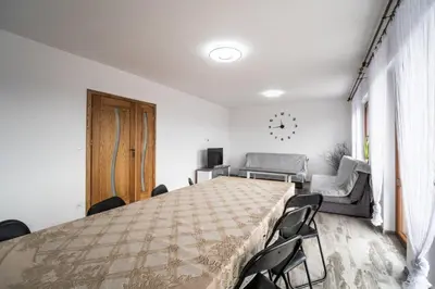 a large room with a large bed and chairs at Michalka 2 - Domki pod Leskowcem in Targoszów