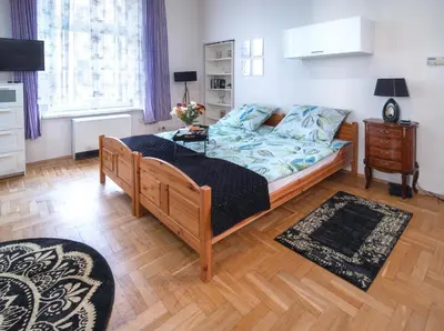 a bedroom with a bed and a wooden floor at Cozy Apartament Rachel-Near Rynek Netflix in Kraków