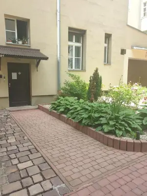 a brick walkway in front of a house at Cozy Apartament Rachel-Near Rynek Netflix in Kraków