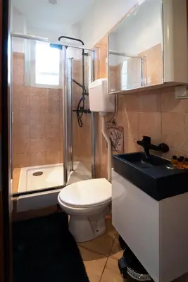 a bathroom with a toilet and a sink and a shower at Cozy Apartament Rachel-Near Rynek Netflix in Kraków