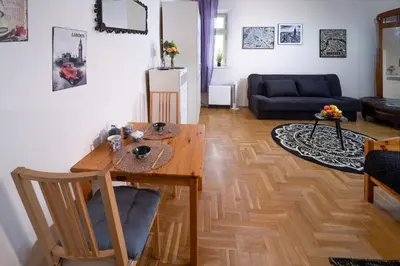 a living room with a wooden table and a couch at Cozy Apartament Rachel-Near Rynek Netflix in Kraków