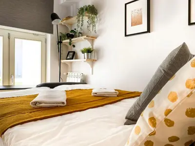 a bedroom with a bed with towels on it at Charming Studio for couples in the heart of Cracow in Kraków