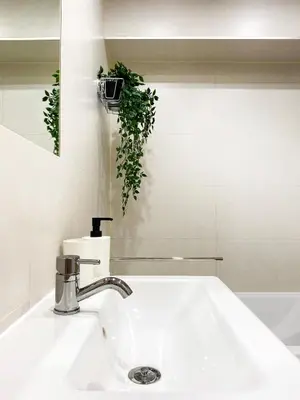 a bathroom with a white sink and a mirror at Charming Studio for couples in the heart of Cracow in Kraków