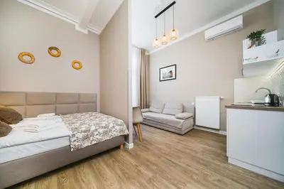 a bedroom with a bed and a couch at Bagel Residence Old Town in Kraków