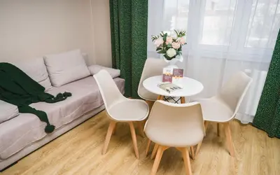 a living room with a couch and a table and chairs at Bagel Residence Old Town in Kraków
