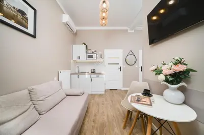 a living room with a couch and a table at Bagel Residence Old Town in Kraków