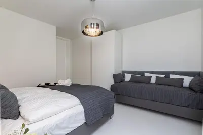 a bedroom with two beds and a chandelier at Ekskluzywny Apartament Garden Residence *Basen/Siłownia* in Kraków