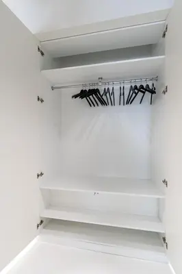 a white walk in closet with white shelves at Ekskluzywny Apartament Garden Residence *Basen/Siłownia* in Kraków
