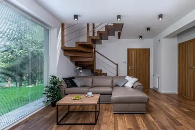 a living room with a couch and a table at Prestigious Residence with Garden, Garage, and Elegant Rooms in Kraków