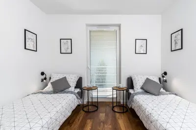 an empty room with a white wall and a door at Prestigious Residence with Garden, Garage, and Elegant Rooms in Kraków