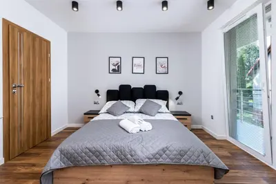 a bedroom with a large bed with two towels at Prestigious Residence with Garden, Garage, and Elegant Rooms in Kraków
