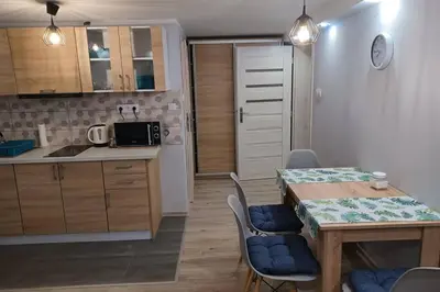 a kitchen and dining room with a table and chairs at Studio Familly-nocleg-Zator- Wadowice-Oświęcim-Kraków in Bachowice