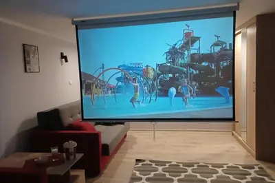 a large screen in a living room with a tv at Studio Familly-nocleg-Zator- Wadowice-Oświęcim-Kraków in Bachowice