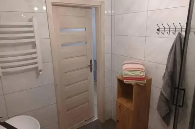a bathroom with a shower and a toilet and towels at Studio Familly-nocleg-Zator- Wadowice-Oświęcim-Kraków in Bachowice