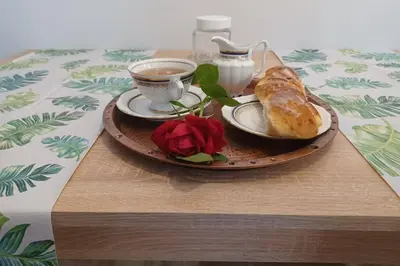 a table with a plate of food and a cup of coffee at Studio Familly-nocleg-Zator- Wadowice-Oświęcim-Kraków in Bachowice