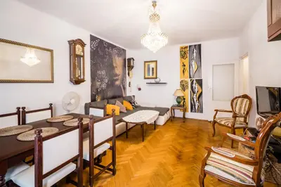 a living room with a table and a couch at Apartament Dębnicki WAWELOFTS in Kraków