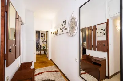 a hallway of a home with a mirror at Apartament Dębnicki WAWELOFTS in Kraków