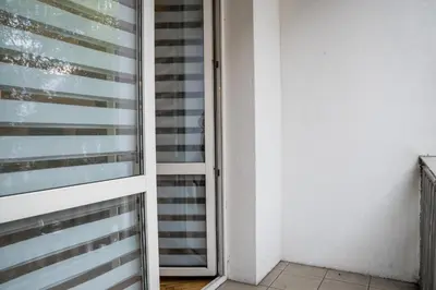 an open door to a room with a window at Apartament Dębnicki WAWELOFTS in Kraków