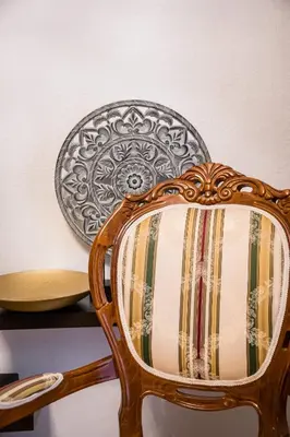 a wooden chair with a plate on a wall at Apartament Dębnicki WAWELOFTS in Kraków