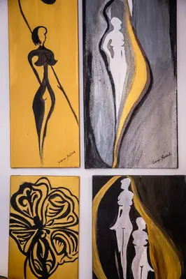 four paintings of a woman in black and yellow at Apartament Dębnicki WAWELOFTS in Kraków