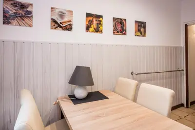 a table with chairs and a lamp on top of it at Apartament Dębnicki WAWELOFTS in Kraków